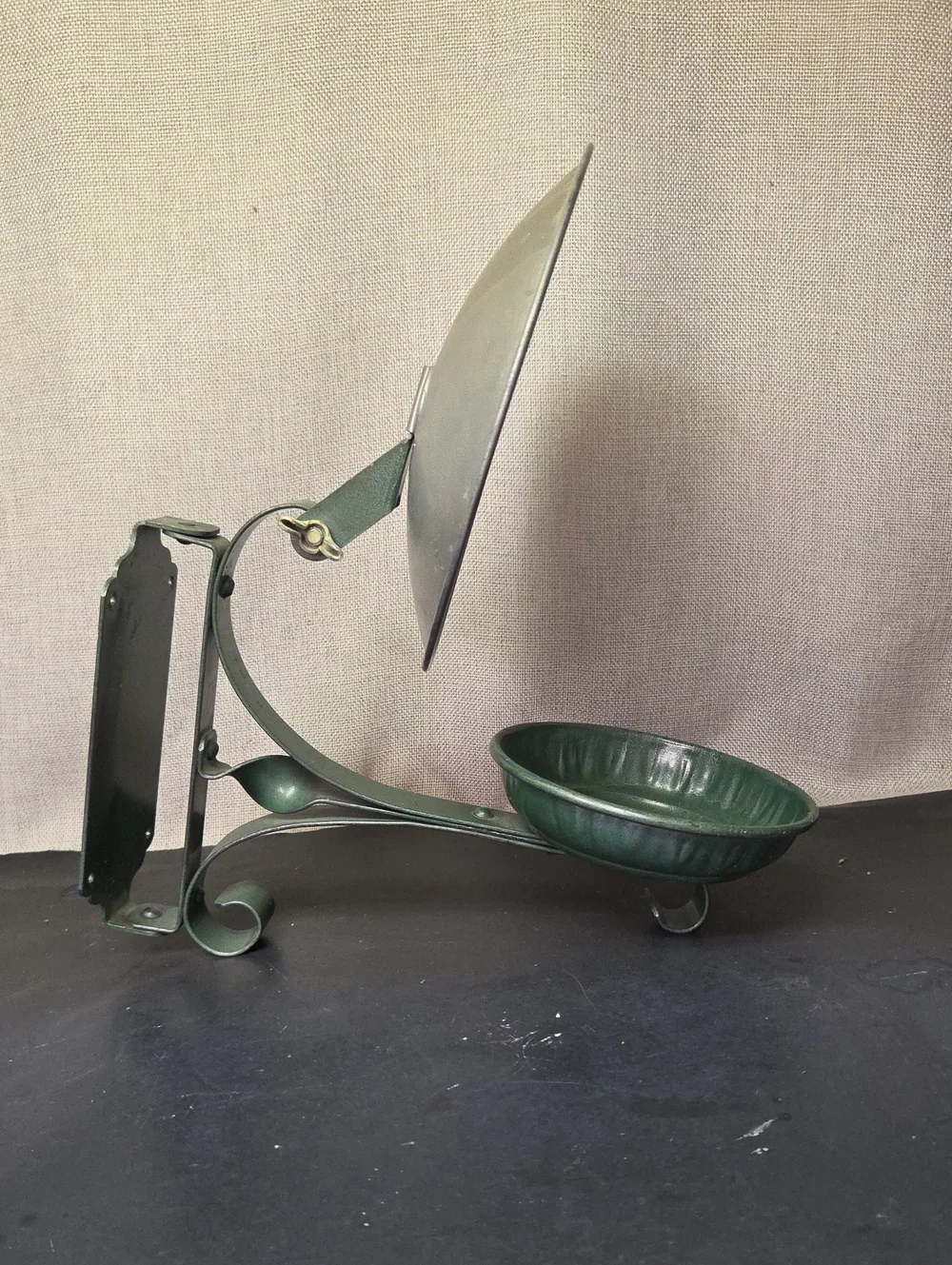 antique cast iron Oil Lamp sconce with a built-in metal reflector.
